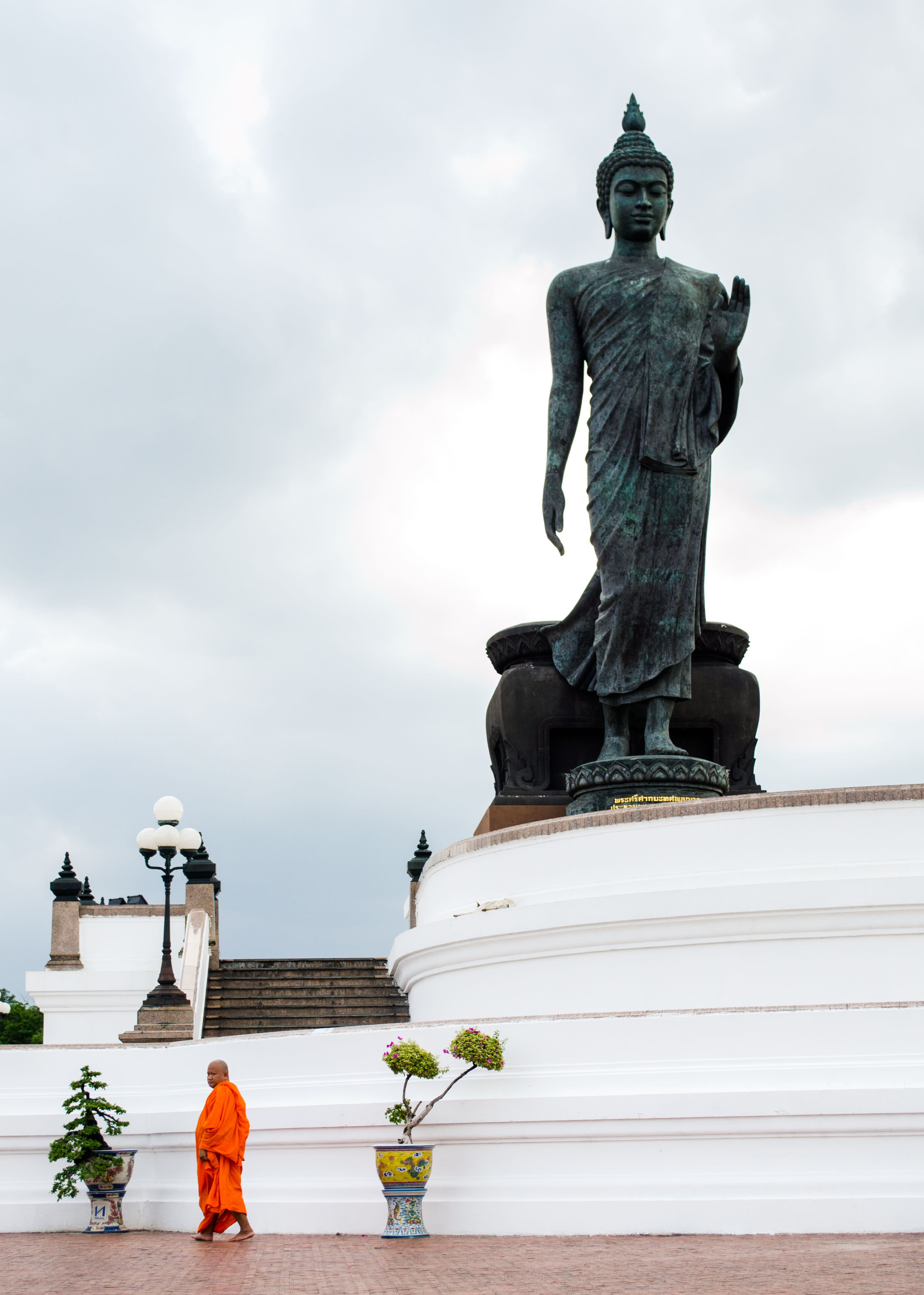 a buddhist monk in puthamonthon park, bangkok, thailand.